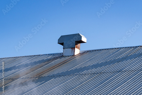 A metal vent on a warehouse