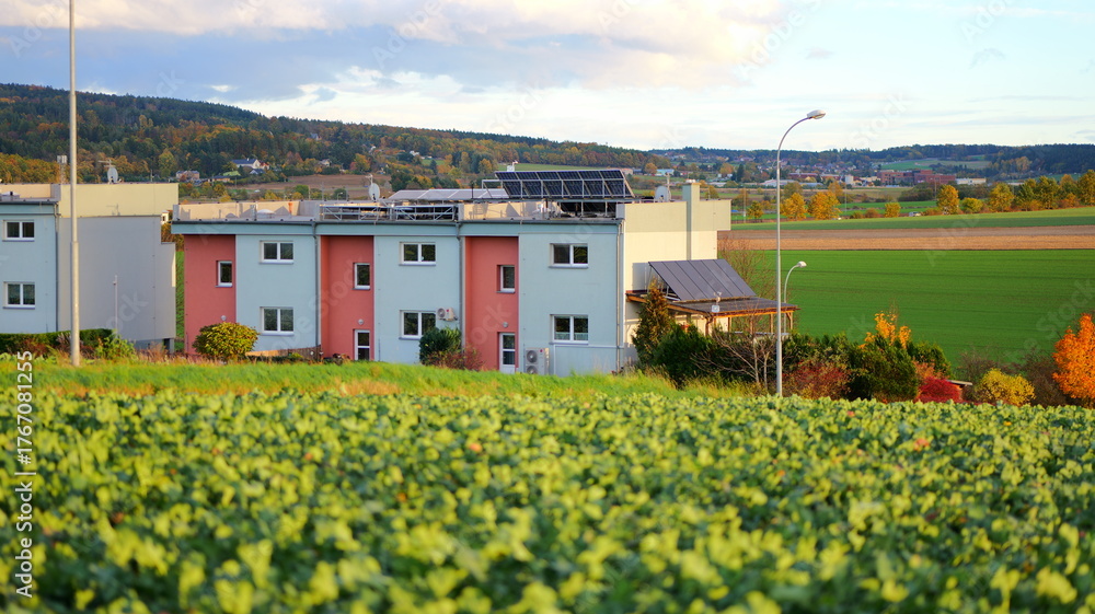 Fototapeta premium Modern apartment building with solar panels. Ideal for illustrating sustainable living concepts