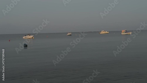 Fishing boats sway on the waves in the  Aegean Sea bay. Relaxing at sea at dawn in summer. Sea in Greece, Halkidiki. Relaxing, calming video