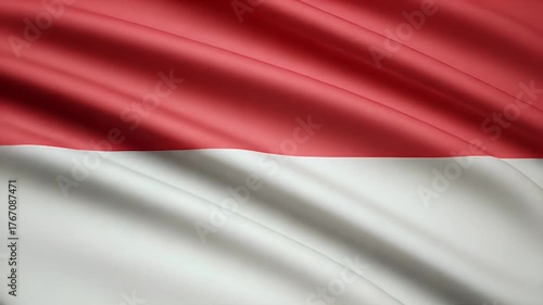 Dynamic motion of the monaco flag waving gently in the breeze creating a patriotic and nationalistic mood with red and white