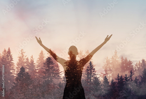 Canvas Print Young joyful woman outdoors with arms up to the sky finding inner strength peace