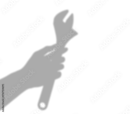silhouette & Shadow of a hand holding a wrench on white background — minimal industrial silhouette concept.
