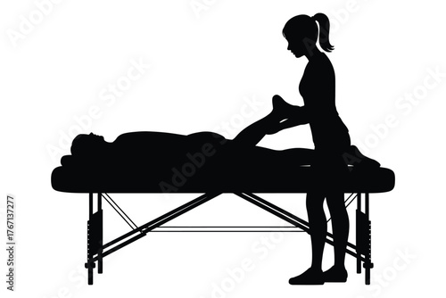 Silhouette of a person receiving a massage on a table