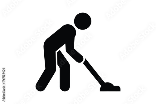 Silhouette of a person vacuuming a floor
