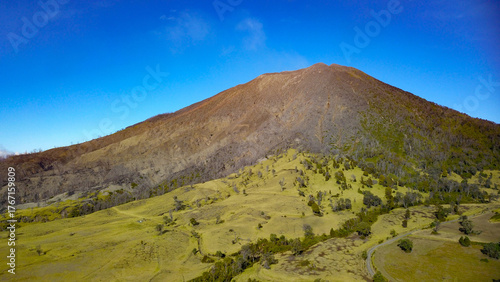 Turrialba Volcano in Costa Rica landscape with green hills and cloudy summer sky