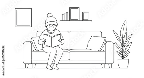 Boy reading book on sofa in cozy living room during winter, enjoying quiet time and warmth indoors. in a professional setting with great clarity.