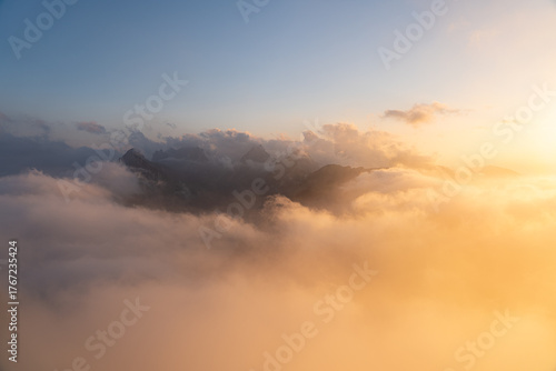 Golden sunset above the Hohen Kasten mountain in Appenzell, Switzerland. Stunning view over the Alps and the Rhine Valley with glowing clouds and peaceful alpine atmosphere.
