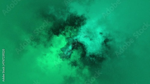 Emerald green cloudscape swirling and shifting in a dynamic atmospheric phenomenon perfect for creative backgrounds
