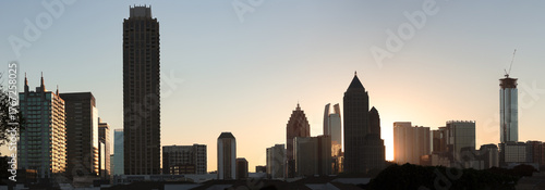 View of Atlanta, Ga skyline during amazing sunrise. The silhouettes of prominent tall buildings, apartments, hotels, office buildings and skyscrapers of downtown backlit by sun. 
