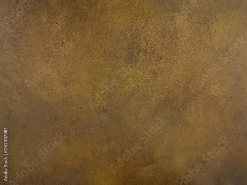 Close up of antique gold metallic washed decorative paint. Dark gold limestone washed textured paint, with abstract grunge and dirt pattern. Seamless background texture.