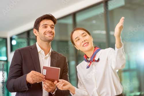 Air woman ground staff advice to a businessman to check in counter of the airport.