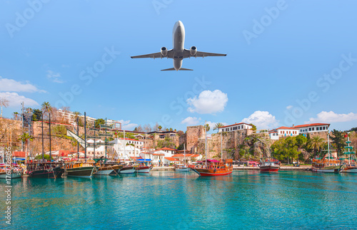 Fototapeta Naklejka Na Ścianę i Meble -  White an air plane fly over the Old Town Kaleici - Antalya, Turkey