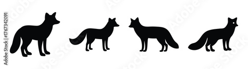 Four silhouette foxes standing in line against a