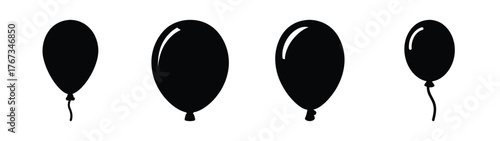 Four realistic black balloons suspended with strings for festive celebrations