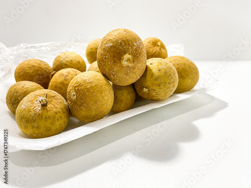 Fresh longan fruit isolated on white background. Tropical exotic fruit minimal still life. Organic longan close up. Sweet healthy fruit photography. Natural clean food concept.