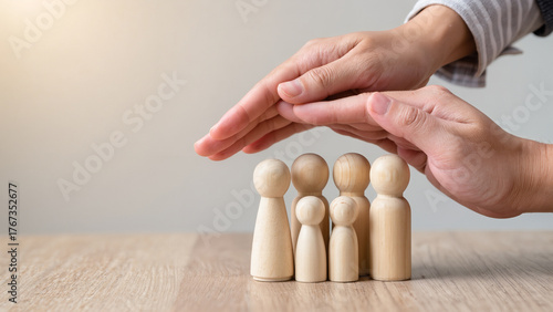 Protecting Hands Over wooden Family, Family Protection And Care Concept, family home, foster care, homeless charity support concept, family mental health