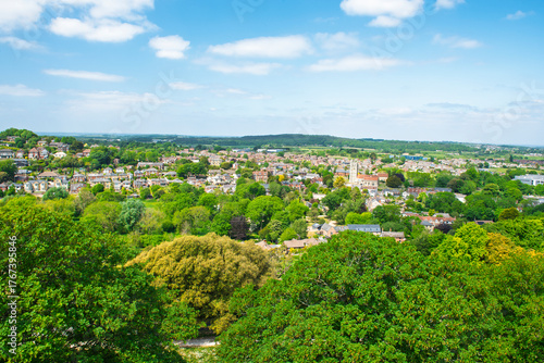 Wallpaper Mural Aerial view over an english rural countryside village amongst trees with panoramic scenery landscape and blue sky background Torontodigital.ca