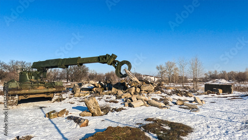 Military tracked vehicle of the engineering troops, clears rubble, carries large logs, concrete beams and building elements.