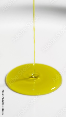 Pouring Olive Oil Onto a White Surface, Close Up