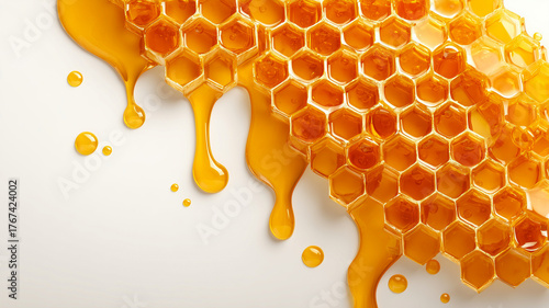 Golden honey dripping from hexagonal honeycomb cells on a white background. Sweet natural organic honey flowing in a minimalist composition, macro photography