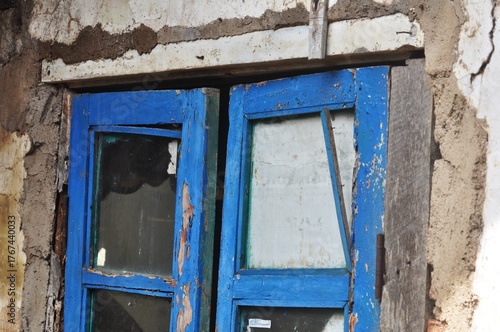 Old Blue Wooden Window on Rustic Wall of Abandoned House