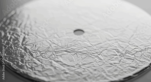 Close-up of a crumpled aluminum foil surface with a small hole detail