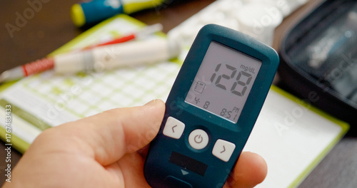 A person checks their glucometer, revealing an elevated blood sugar level. This highlights the ongoing challenge of diabetes management and monitoring health.