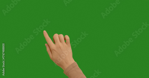 Woman hand making gestures lines, curves, graphics on chroma key green screen background. Dragging and Swiping on Chroma Key Green Background, like using a Smartphone, Tablet Pc or a Touchscreen.