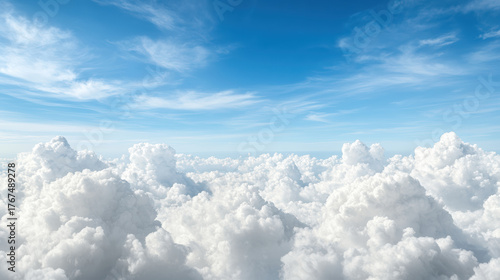 Fototapeta Naklejka Na Ścianę i Meble -  Fluffy white clouds fill sky, creating serene and cinematic atmosphere