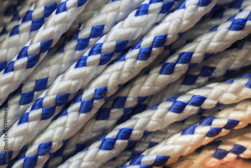 Close up view of strong blue and white braided nylon rope texture. durable cord showing detailed pattern, perfect for nautical or utility backgrounds and concepts