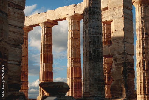 Ancient Greek temple of Poseidon at dusk. Marble columns in the sun.