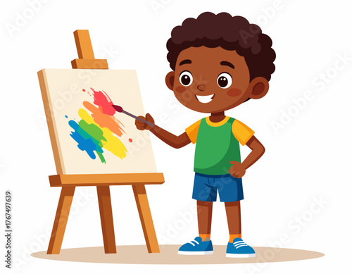 Cute little African American boy artist happily painting a colorful abstract picture on a canvas with a wooden easel