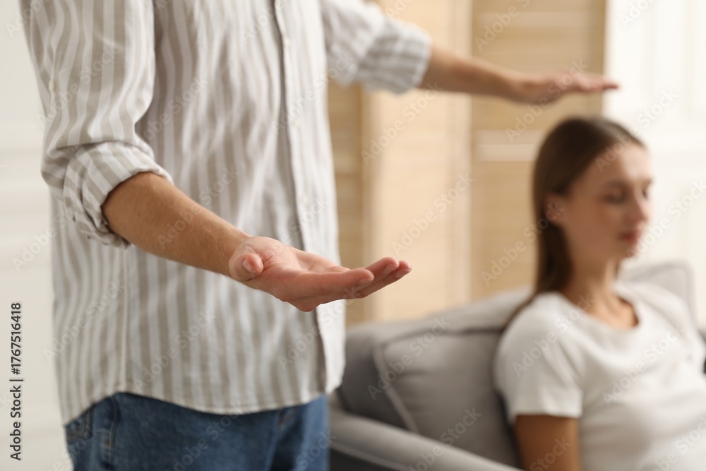 Fototapeta premium Reiki master showing his hand while healing patient's aura during therapy indoors, closeup