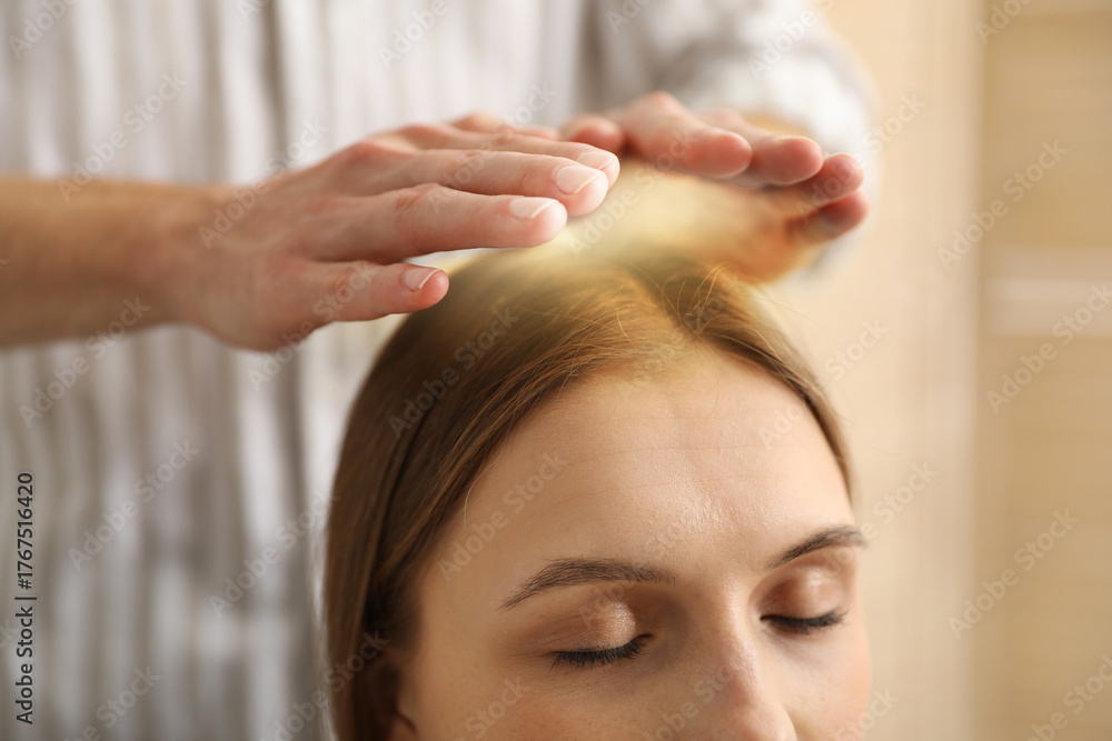 Fototapeta premium Reiki master healing patient's aura during therapy indoors, closeup