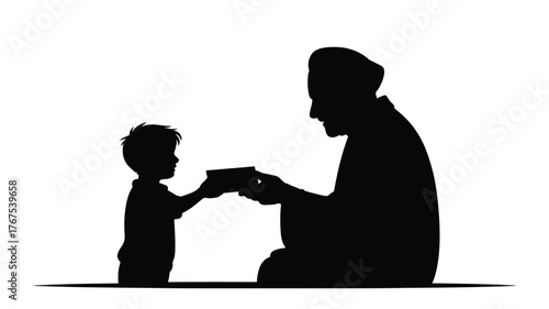 Silhouette of a child giving a rectangular object to an adult wearing a head covering while kneeling