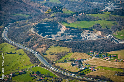 Vászonkép Aerial view of the Urugne area showcasing green fields, a quarry site, and a highway