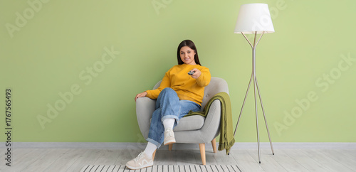 Young woman with remote con...