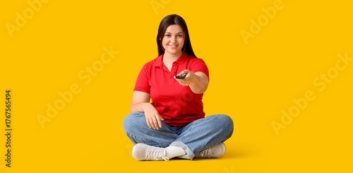 Young woman with remote con...