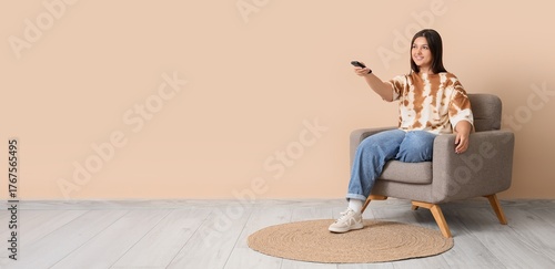 Young woman with remote con...