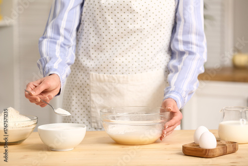 Woman putting spoon of suga...