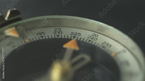 Close-up footage of a vintage compass with smooth panning and rotation motion
