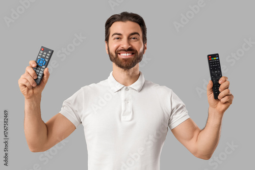 Young man with TV remote co...