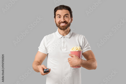 Young man with TV remote co...