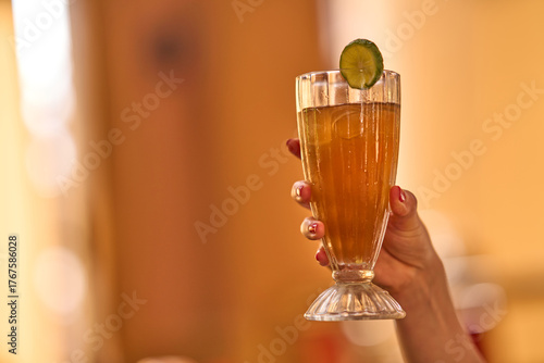 Female hand holding a mule glass