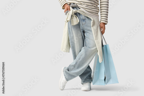 Konstfotografi Stylish young man with shopping bags on white background