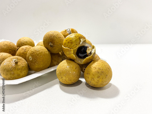 Fresh longan fruit isolated on white background. Tropical exotic fruit minimal still life. Organic longan close up. Sweet healthy fruit photography. Natural clean food concept.