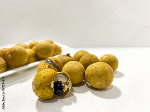 Fresh longan fruit isolated on white background. Tropical exotic fruit minimal still life. Organic longan close up. Sweet healthy fruit photography. Natural clean food concept.
