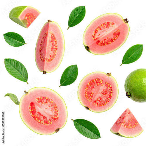 Overhead shot of guava fruits (cut & whole) with leaves scattered on black background