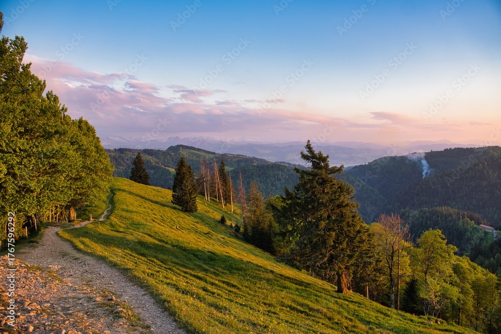Obraz premium Hiking up the beautiful Schnebelhorn hill in the canton of Zurich. Sunset at the highest point in Zurich. Hiking in Switzerland. High quality photo