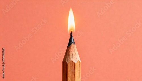 A close-up studio shot shows a pencil with a flame burning at its tip
